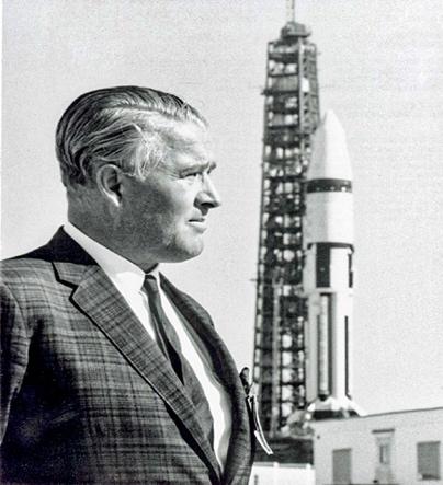 A person standing in front of a tall tower Description automatically generated with low confidence