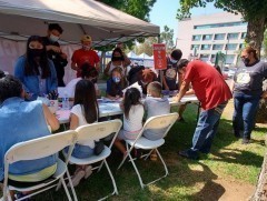 Children, their parents, and grandparents writing and coloring letters for refugee children. Writing and coloring letters for refugee children